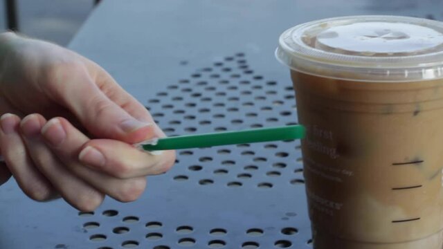  Putting Straw Into Iced Coffee