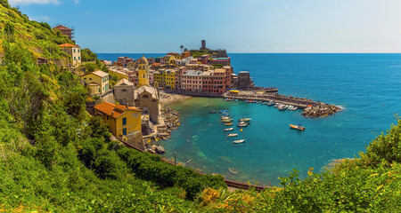 Fototapeta na wymiar A panorama view over the picturesque village and harbour of Vernazza in the summertime
