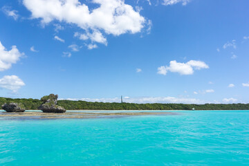 Amazing seascape of Pines Island, new caledonia: turquoise lagoon, typical rocks, blue sky