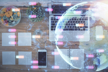 Double exposure of map hologram drawing over study table background with computer. Concept of international network. Top view.