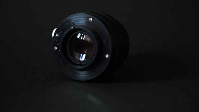 Old manual lens on a black background