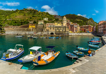 Fototapeta na wymiar A panorama view of boats in the harbour of the picturesque village of Vernazza in the summertime
