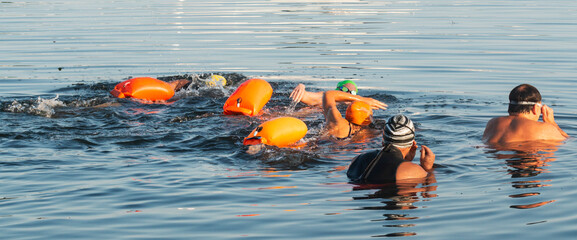 Group of swimmers starting to swim a 5K for charity in the bay