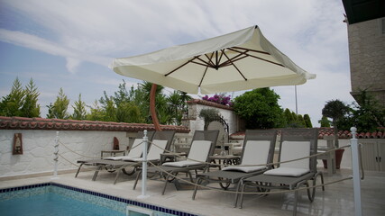 Fototapeta premium Modern deck chairs near the pool 