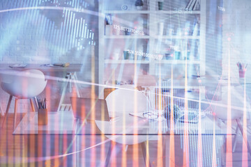 Double exposure of financial graph drawing and office interior background. Concept of stock market.