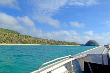 Fototapeta na wymiar Boat view on one of the tropical islands of Fiji, beach, rock and full of palm tree