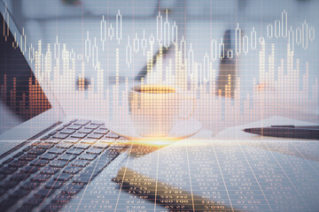 Double exposure of financial chart drawing and desktop with coffee and items on table background. Concept of forex market trading