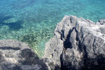 Big bouldering rock above the turquoise water in Fiji