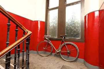 red bicycle on tenement stairway