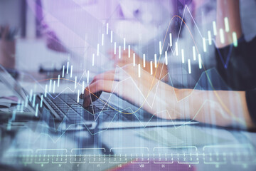 Multi exposure of woman hands typing on computer and financial graph hologram drawing. Stock market analysis concept.