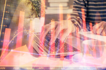 Double exposure of woman hands typing on computer and forex chart hologram drawing. Stock market invest concept.