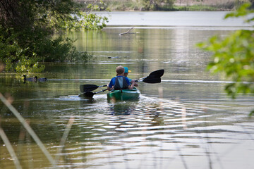 Obraz na płótnie Canvas Young boys Kayaking on calm lake
