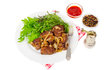 Pieces of fried liver with onions, fresh leaves of salads