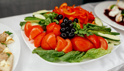 vegetable plate with tomato cucumbers olives and red pepper 