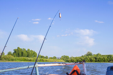 waves from a small wooden motor boat while searching for a drowned man