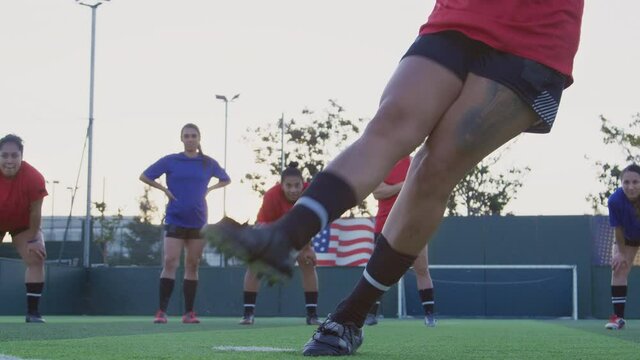 Close up of player shooting and scoring goal from penalty kick as team mates celebrate - shot in slow motion