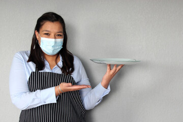 Latin woman waitress working with face masks and protective gloves, new normal by covid-19