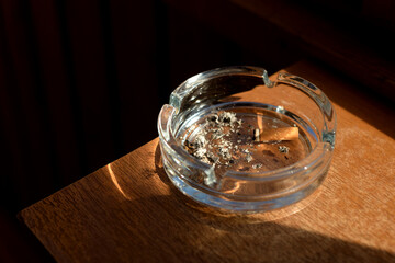 Ashtray with a cigarette butt.