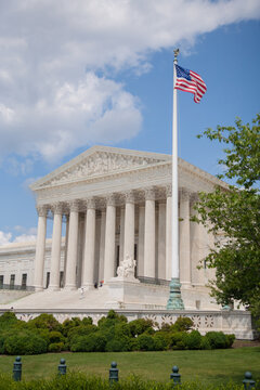 Washington DC -6/27/2009: The supreme court building with flag. The Supreme Court of the United States is the highest federal court of the United States.