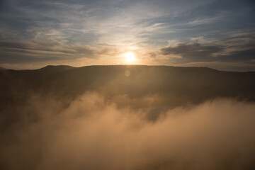 Orange sunset view at mountains in Azerbaijan. Cloudy weather.