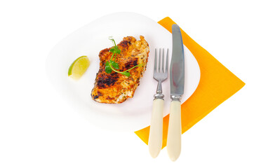 Piece of fried chicken with spices on white plate.