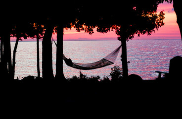 Silhouette of a Hammock Ahead of Lake Michigan Under the Sunset