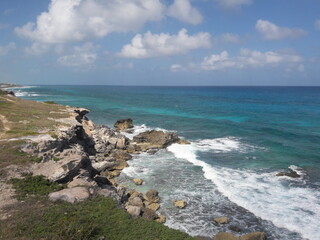 Fototapeta na wymiar Isla Mujeres South Point Cancun Mexico blue water crashing against rocky shores 2020