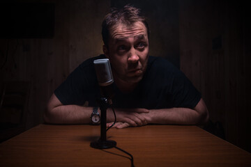 Serious reporter in television studio looking at the camera