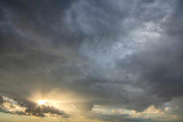 Sunset sky covered with dramatic storm puffy clouds before rain.