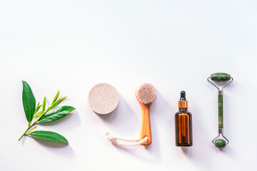 Essential oil, lavender soap, face roller and wooden brush, top view, flat lay, copy space