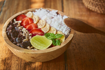 Close up fruit bowl in wooden plate on the rustic table