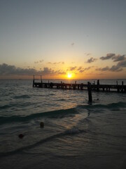 Fototapeta na wymiar Sunset at beach with a dock on Isla Mujeres Cancun Mexico 2020