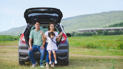 Asian family.happy little girl with family sitting in the car.Car insurance concept