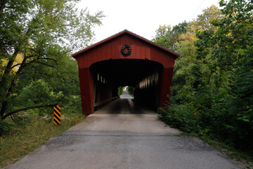 Red covered bridge crossing the wildcat creek.