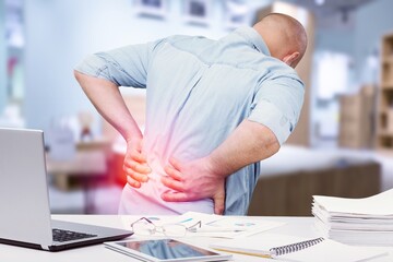 Business man with back pain in office