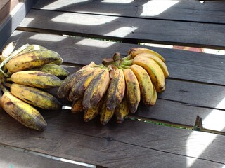 ripe bananas on a black wood background