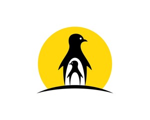 Obraz premium Simple penguin child and mother with sunrise behind