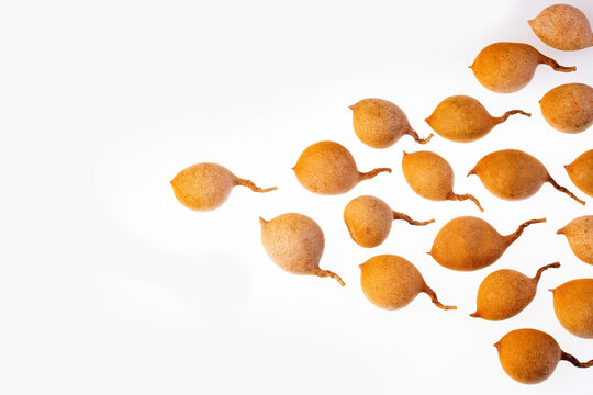 Tamarindus indica - Fresh tamarind fruits on white background