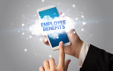 Female hand touching smartphone with EMPLOYEE BENEFITS inscription, cloud business concept