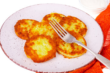 Vegetable marrow pancakes with white sauce. Photo
