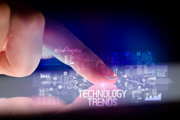 Finger touching tablet with web technology icons and TECHNOLOGY TRENDS inscription