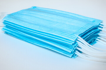 Close up of isolated pile of stacked light blue ear loop mask