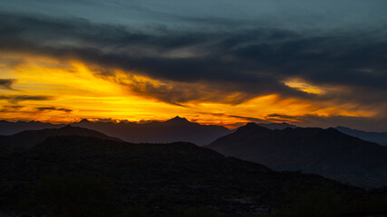 Sunset over desert mountain range