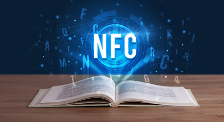 NFC inscription coming out from an open book, digital technology concept