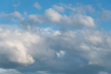 Fototapeta na wymiar Atmospheric blue sky with gray and white clouds 