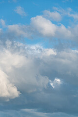 Fototapeta na wymiar Atmospheric blue sky with gray and white clouds 