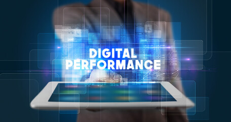 Young business person working on tablet and shows the inscription: DIGITAL PERFORMANCE