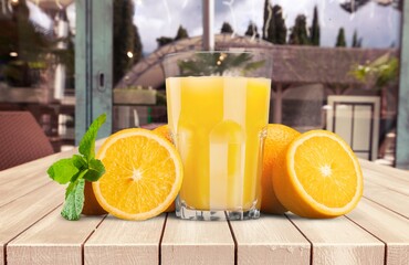 Orange juice and slices of orange on wooden desk © BillionPhotos.com