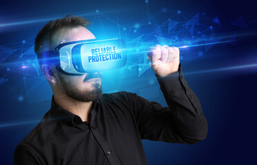 Businessman looking through Virtual Reality glasses with RELIABLE PROTECTION inscription, cyber security concept