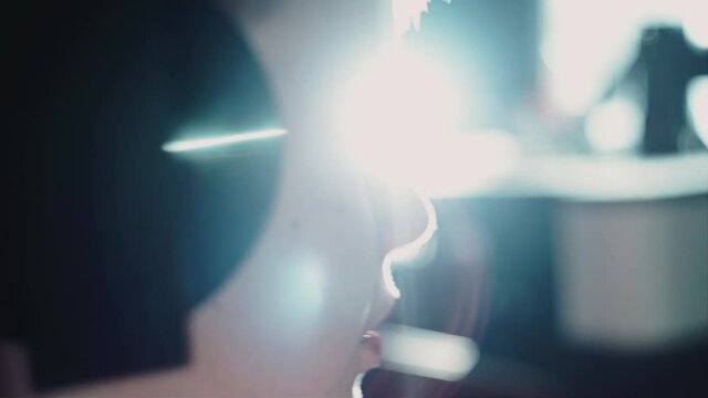 A boy plays a video game and mumbles something to himself. Close up. Side view. Entertainment at home.